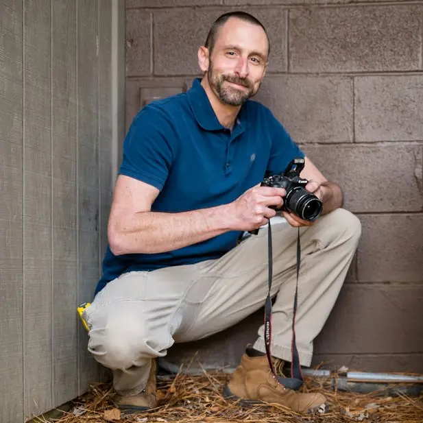 Photo of home inspector Chad with a camera.