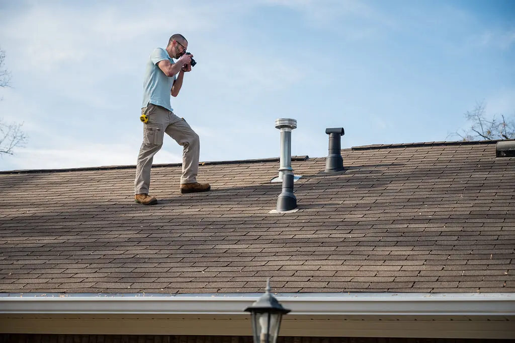 Photo of home inspector Chad inspecting a roof.